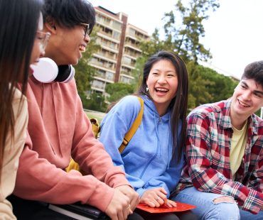 Education high school and people concept - group of happy teenage students with notebooks having fun