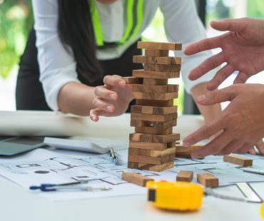 Two engineers are consulting on building design. Teamwork success is a technique of successful work.